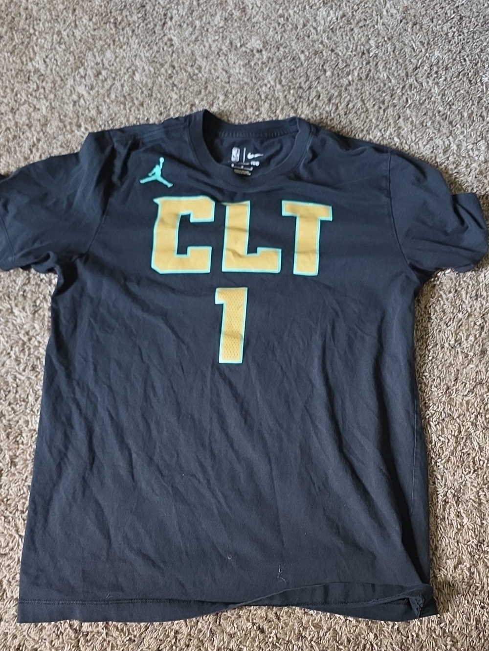 The Nike Tee Black Tee with Teal Jumpman and Gold-Outlined CLT Graphics